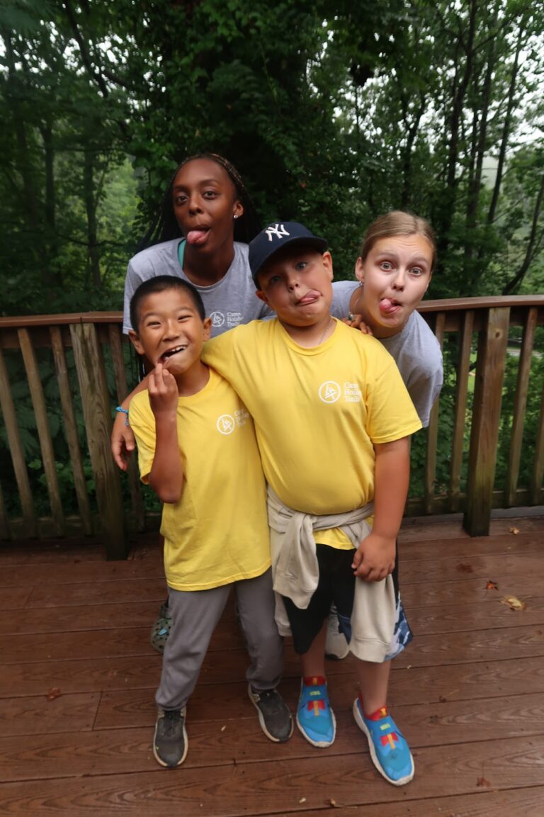 Two camp counselors with two camps, silly faces 2023