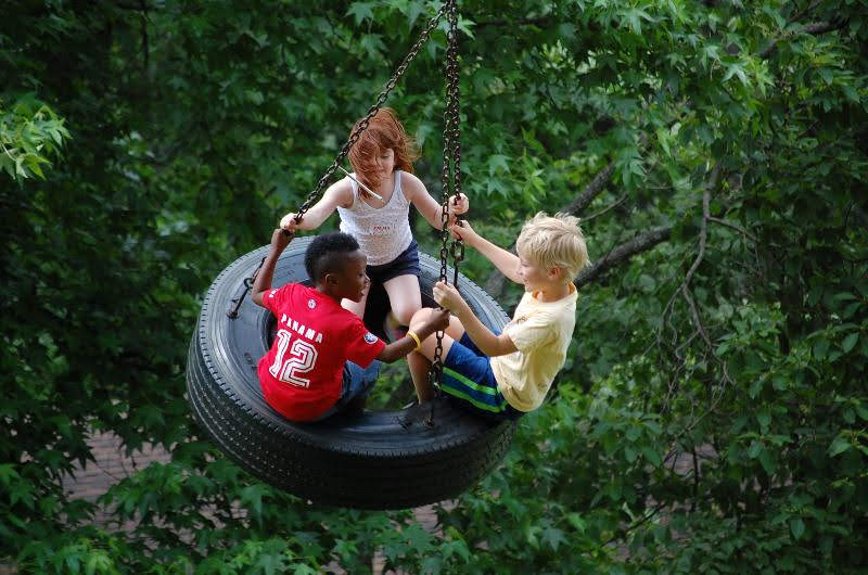 campers in a tire swing